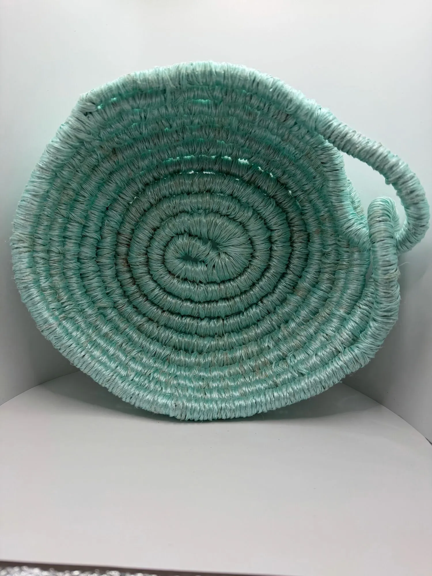 Coiled aqua rope basket with a side handle